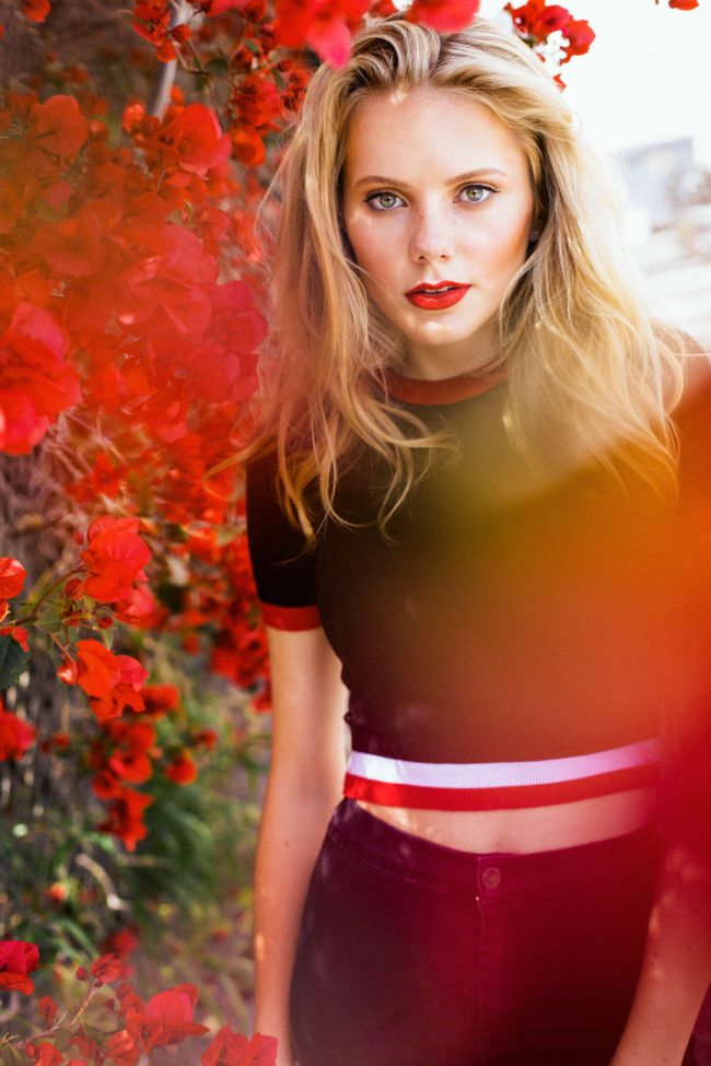 Maddie Reed with Red flowers photographed in Los Angeles by Chris Wood