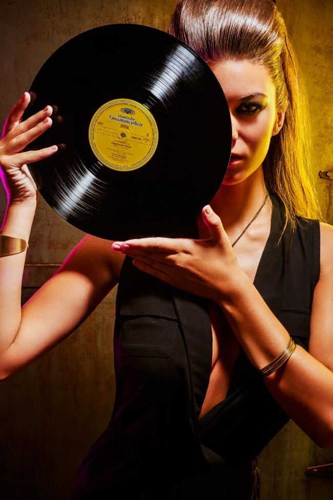 Model with Dark Makeup Holding Record